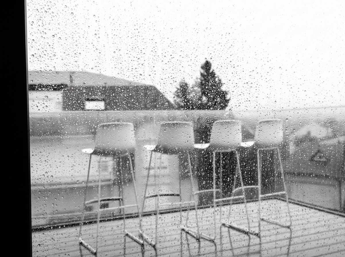 Rain-streaked window over the outdoor terrace