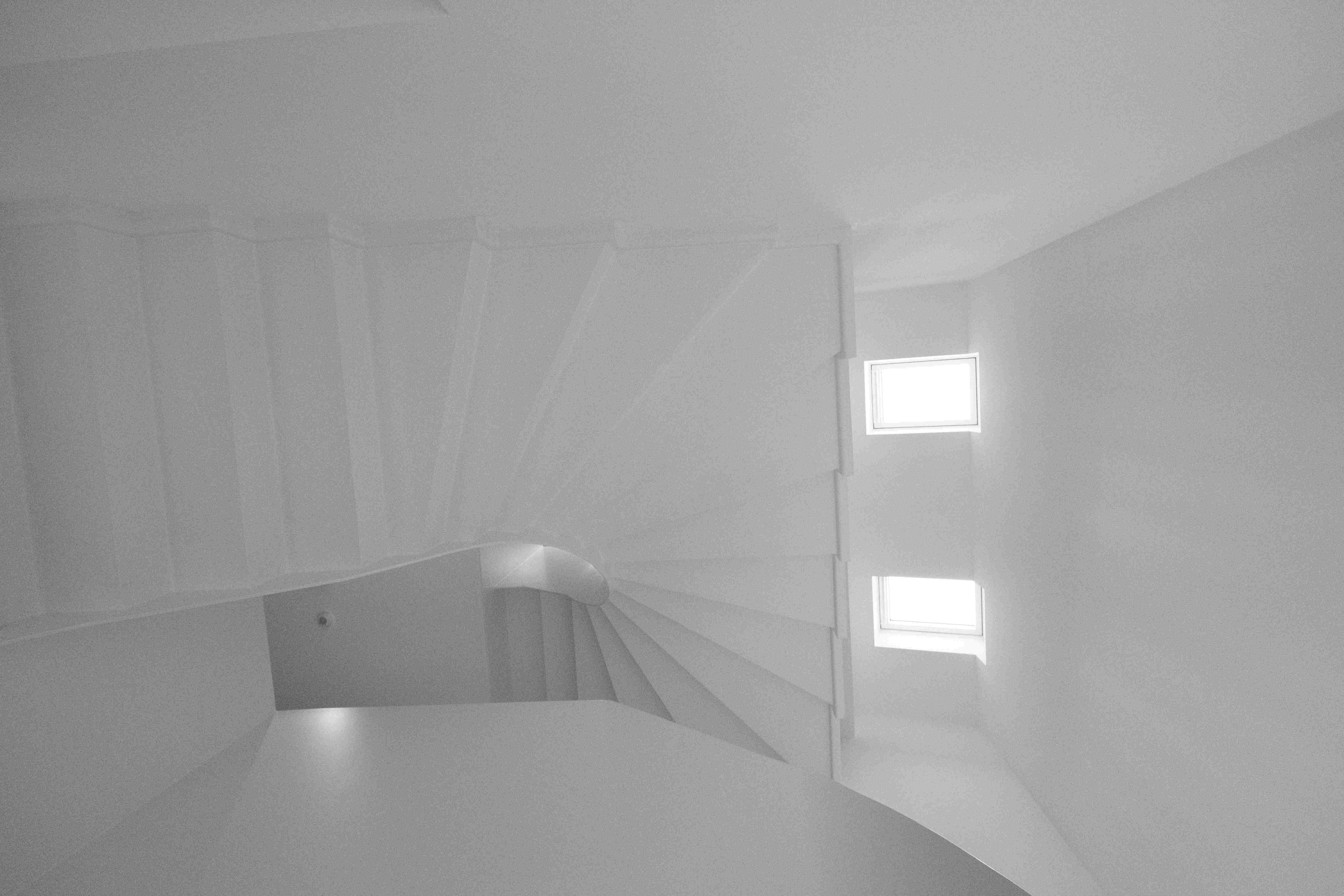Stairwell rising toward two skylights